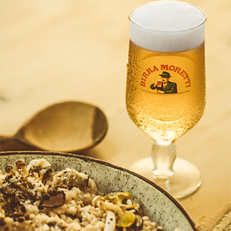Birra Moretti and a truffle dish on the table